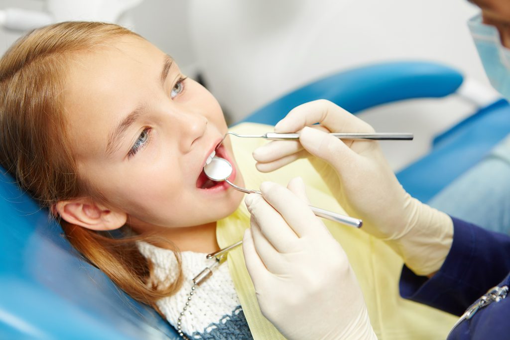 little caucasian girl sitting chair pediatric dentistry clinic early prevention raising awareness oral hygiene demonstration concept